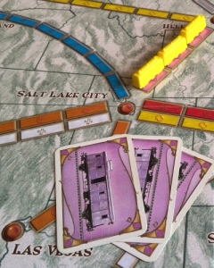 Yellow plays three pink cards to complete this three-train route between Helena and Salt Lake city